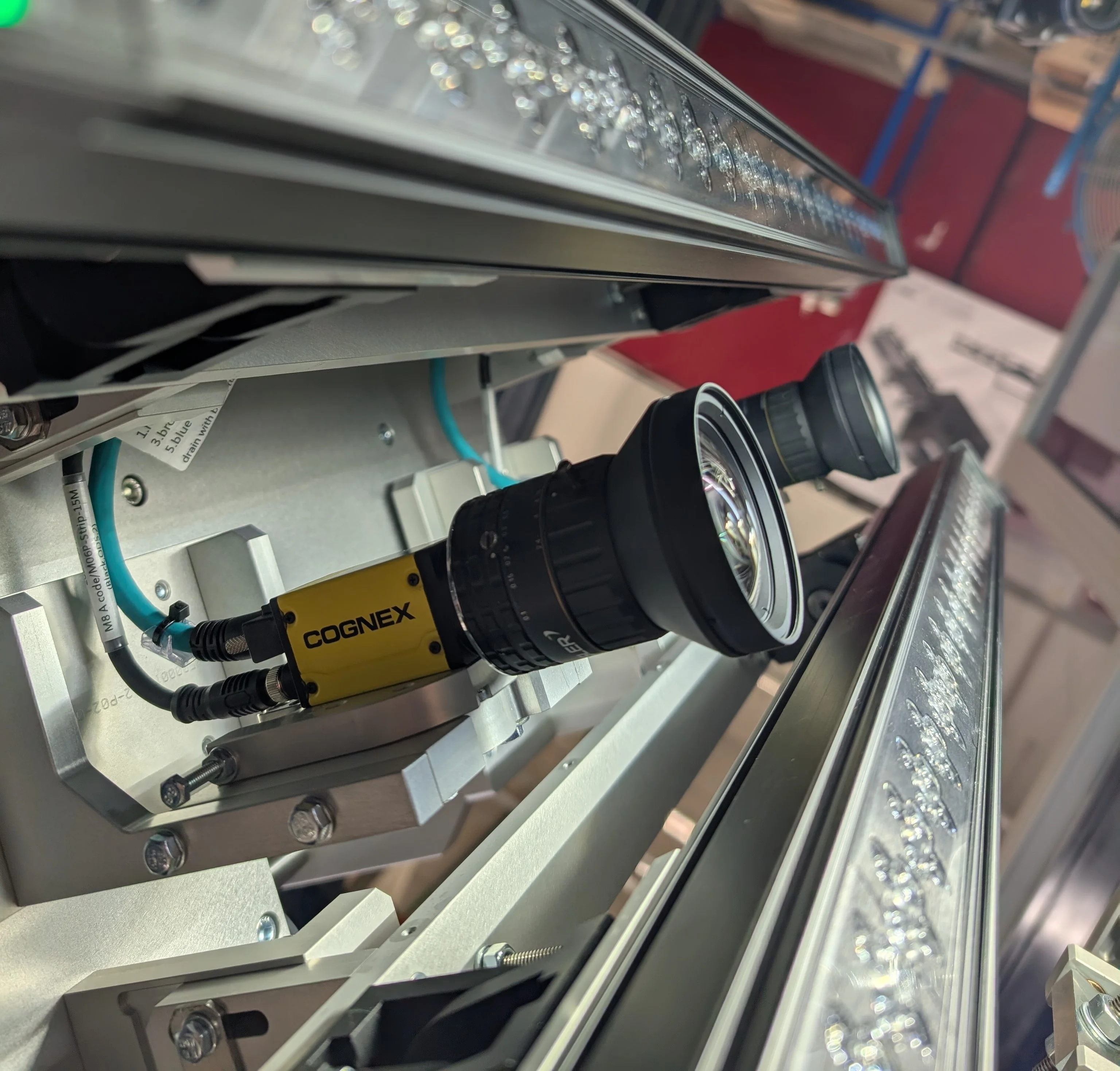 Line scan and area scan cameras inspecting a printed consumer product box