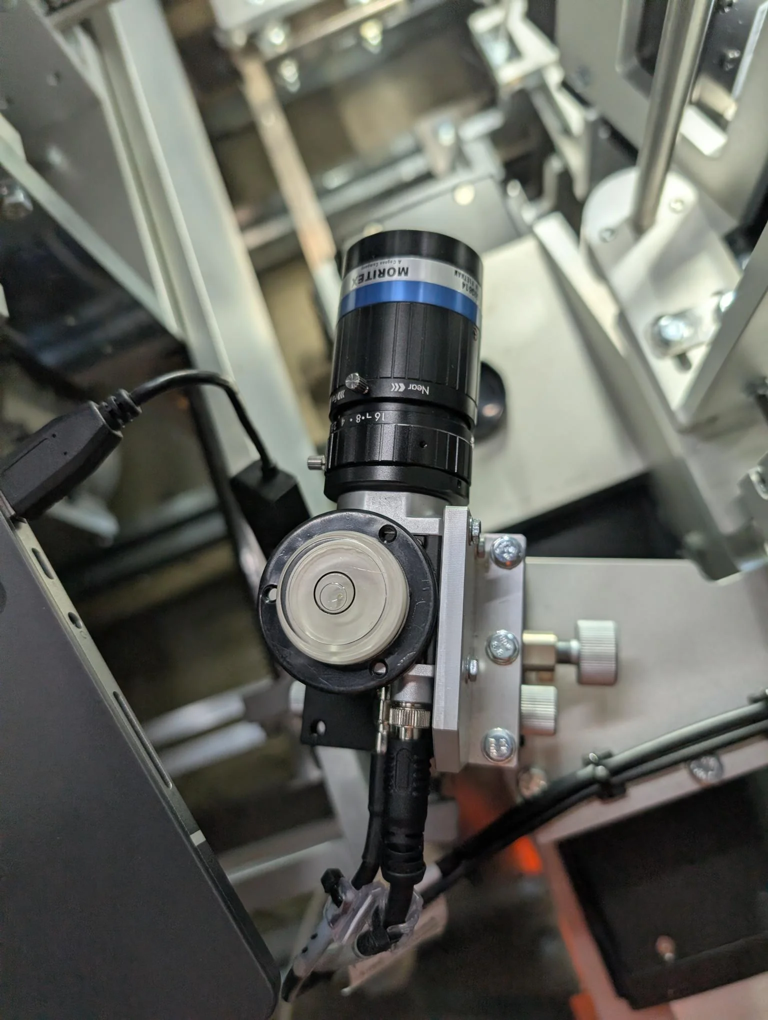 Boxed consumer product moving through the six-face inspection cell