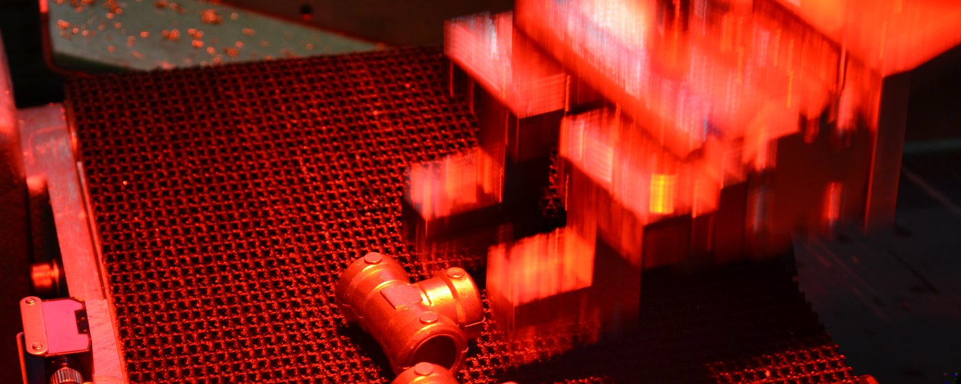 Red-lit conveyor with parts and robot arm